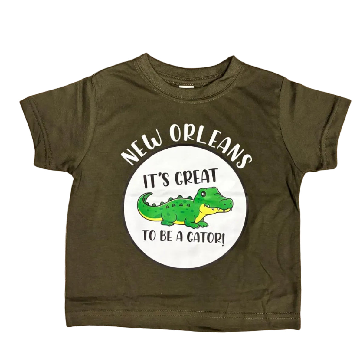 A toddler t-shirt with the Gator printed in the center of a circle with the words "It's Great to be a Gator!" and New Orleans above the circle was placed on a white backdrop.