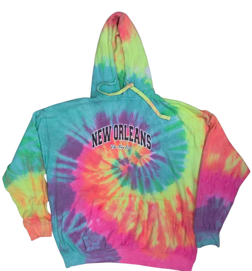 A multicolor tie-dye pullover hoodie with a spiral pattern in pink, orange, yellow, green, and purple. The front features the words 'NEW ORLEANS' printed in arched black letters with a white outline, and a small 'French Quarter' script underneath.