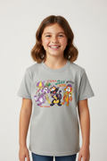 A smiling young girl with shoulder-length brown hair wearing a light gray heather graphic t-shirt. The shirt features a colorful cartoon print of Disney's New Orleans Jazz & Heritage Museum characters and the text 'COOL Jazz Club New Orleans'.