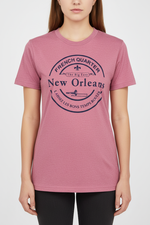 A woman wearing a heathered cardinal  short-sleeve t-shirt with a dark navy blue graphic print on the front that reads 'French Quarter New Orleans'.