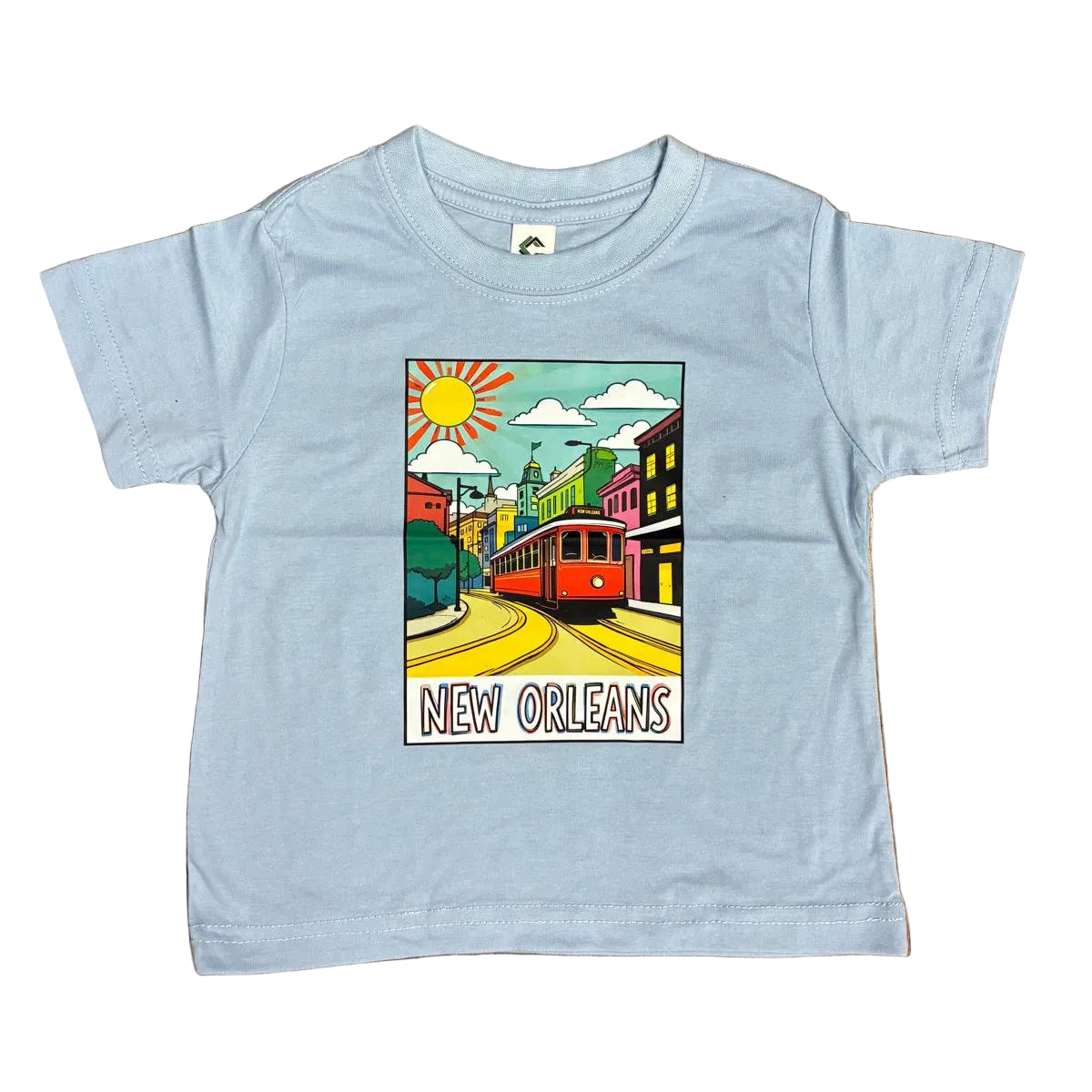A light blue short-sleeve kids' t-shirt with a colorful 'New Orleans' graphic print, laid flat on a white floor.